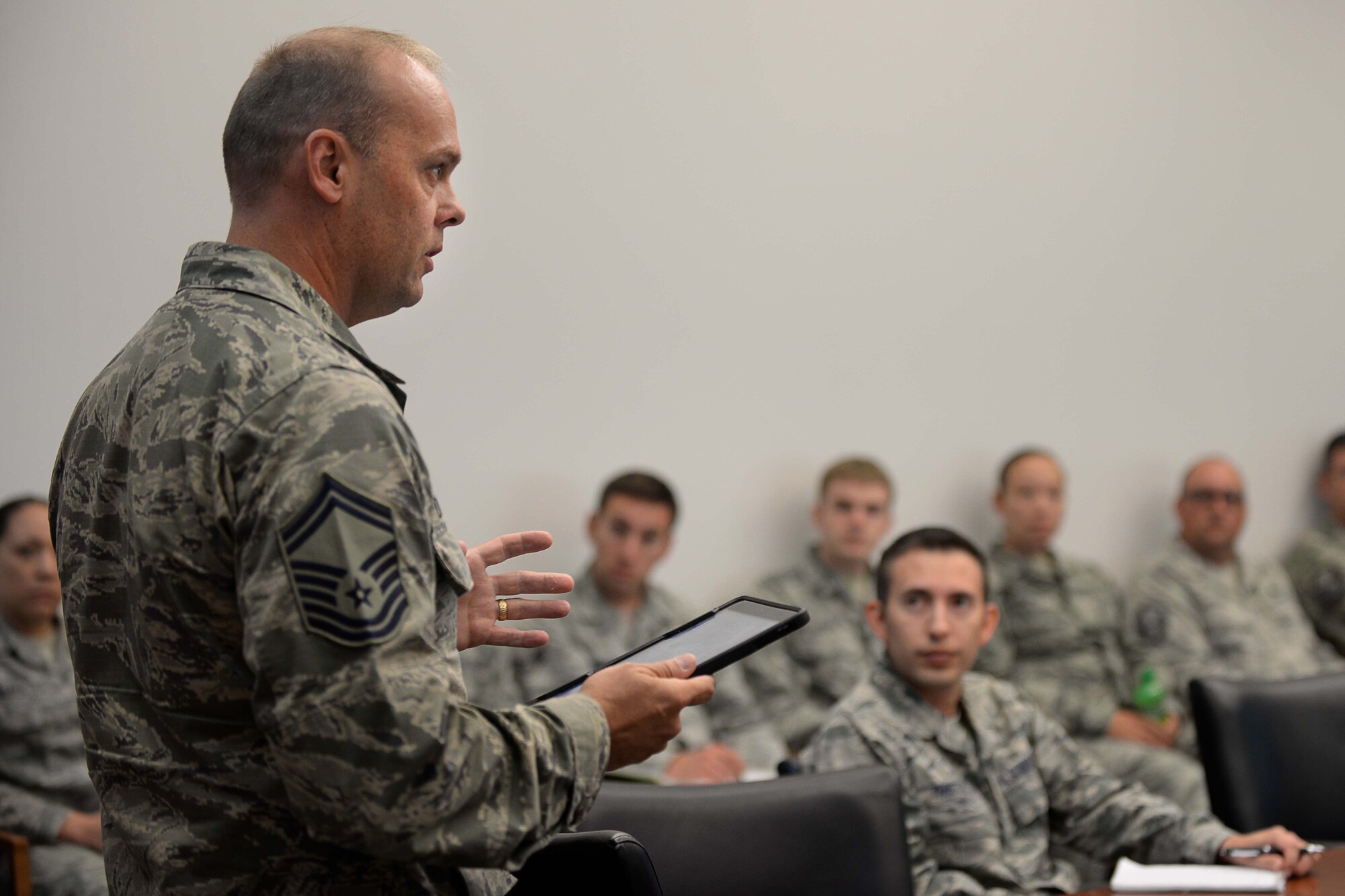 Senior Master Sgt. Edward Dierkens, Headquarters Air Combat Command superintendent of maintenance integration, informs Airmen on the capabilities of the newly implemented iPads at Ellsworth Air Force Base, S.D., Sept. 9, 2015. Air Combat Command bases have fully transitioned to using iPads to conduct daily operations, replacing the toughbooks which were previously used. (U.S. Air Force photo by Senior Airman Rebecca Imwalle/Released)