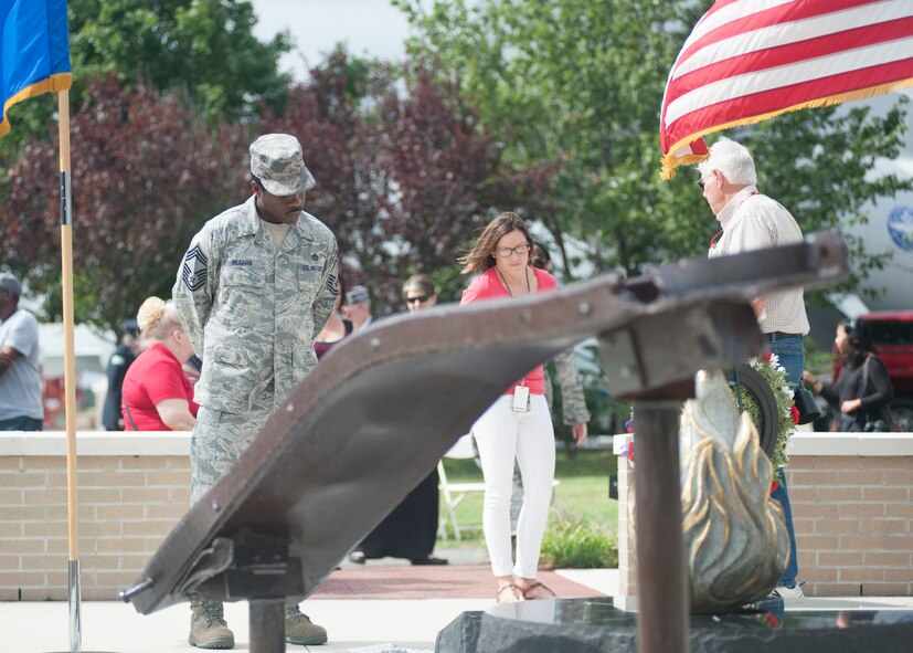 Chief Master Sgt. Naim Vaughan, 436th Civil Engineer Squadron superintendent, reads the stone placard during the 9/11 memorial service Sept. 11, 2015, at the Air Mobility Command Museum on Dover Air Force Base, Del. (U.S. Air Force photo/Staff Sgt. Jared Duhon)