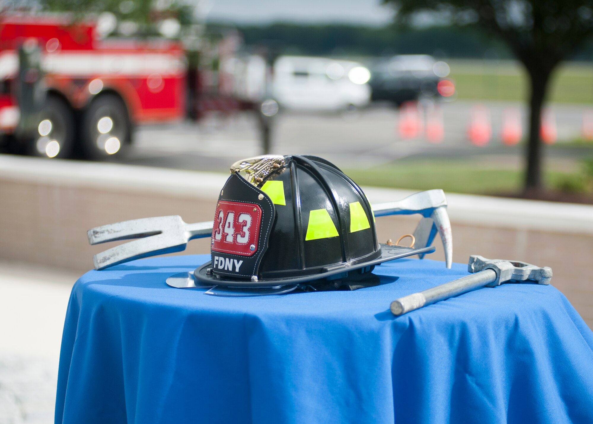 Firefighters’ equipment rests on a table during the 9/11 memorial service Sept. 11, 2015, at the Air Mobility Command Museum on Dover Air Force Base, Del. The memorial incorporates two pieces of steel from World Trade Center, a rock from the United Airlines Flight 93 crash site and a block from the damaged portion of the Pentagon. (U.S. Air Force photo/Staff Sgt. Jared Duhon)