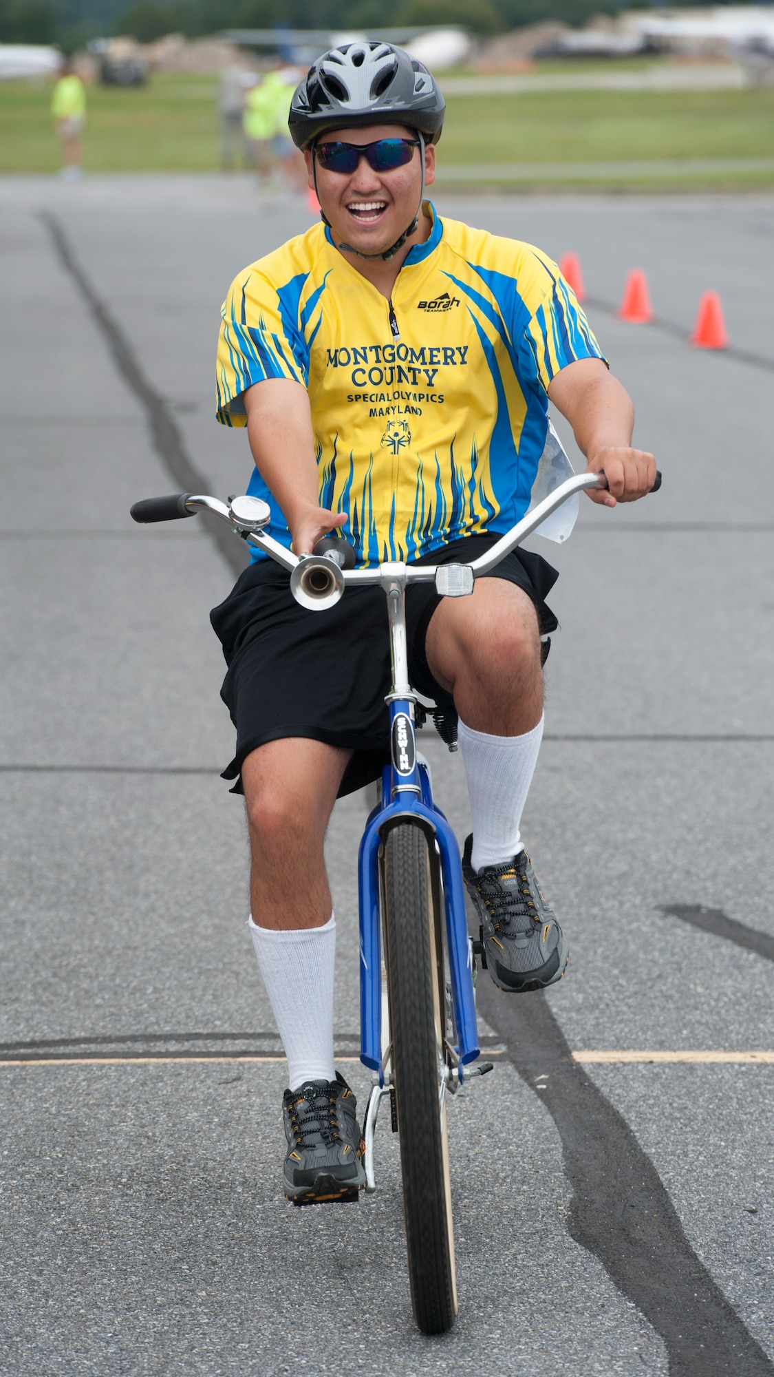 Matthew Ross, Team Montgomery County cyclist, honks his horn as he crosses the finish line at the 2015 Special Olympics Cycling Classic Sept. 12, 2015, at Dover Air Force Base, Del. The event was supported by more than 115 Team Dover volunteers. (U.S. Air Force photo/Airman 1st Class Zachary Cacicia)