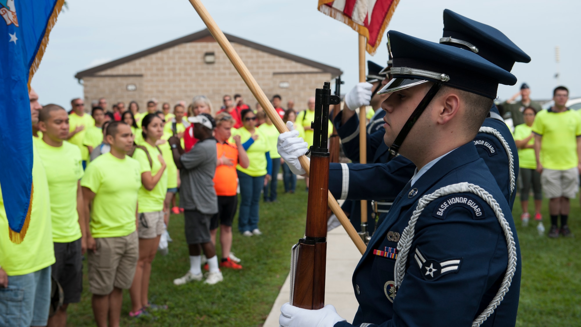 The Dover Air Force Base Honor Guard present colors at the 2015 Special Olympics Cycling Classic Sept. 12, 2015, at Dover Air Force Base, Del. The national anthem was sung by Staff Sgt. Justin Snowden, 436th Operations Support Squadron weather technician. (U.S. Air Force photo/Airman 1st Class Zachary Cacicia) 