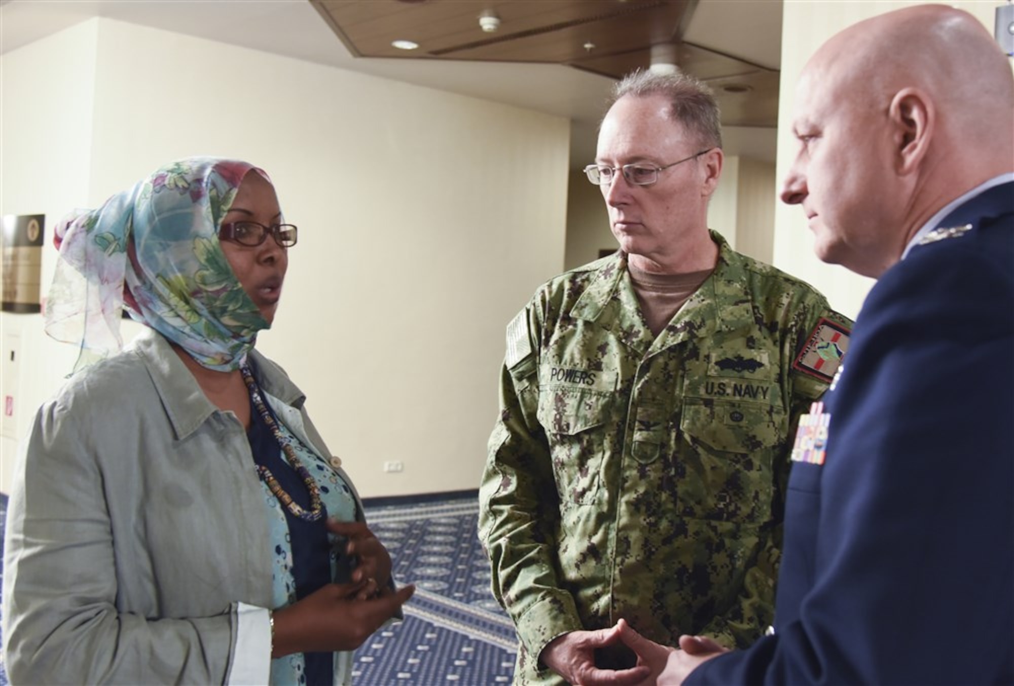 Djibouti Armed Forces Lt. Amina Ahmed Farah, Combined Joint Task Force-Horn of Africa Capt. Roland Powers and U.S. Air National Guard Col. Mike Cooper, discuss priorities in medical training at Ramstein AB, Germany, Aug. 25, 2015. The goal of this symposium was for African partners to possess greater medical support capacity and the ability to sustain medical readiness through African institutions. (U.S. Air Force photo by Master Sgt. Charlene M. Spade/released) 