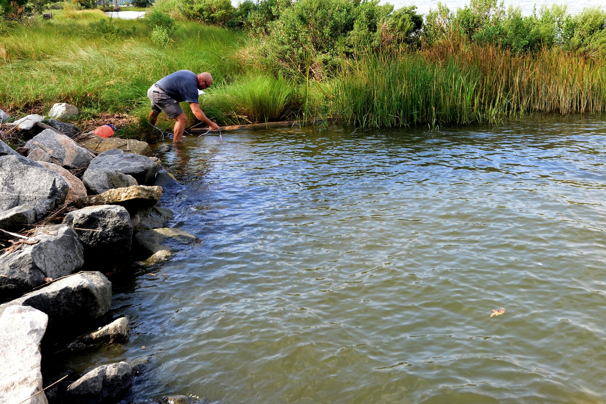 Al Dempsey, Department of Defense environmental prototype evaluator, moves a seismic sensor used to collect seismic wave data at Fort Eustis, Va., Sept. 10, 2015. The sensor was moved closer to shore to pick up a more accurate reading of seismic waves. (U.S. Air Force photo by Staff Sgt. Natasha Stannard/Released)