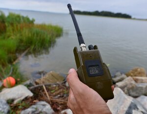 Chris Bravo, Department of Defense environmental prototype evaluator, uses a seismic receiver to collect seismic wave data at Fort Eustis, Va., Sept. 10, 2015. The receiver was remotely connected to a sensor that detected seismic and magnetic waves caused by foot traffic, cars and trains. (U.S. Air Force photo by Staff Sgt. Natasha Stannard/Released)