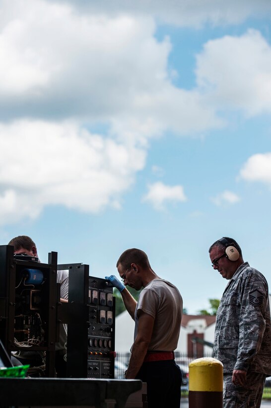 U.S. Air Force Airmen assigned to the 1st Maintenance Squadron aerospace ground equipment flight perform preventative maintenance at Langley Air Force Base, Va., Sept. 9, 2015. The AGE flight uses hardware, smoldering techniques, technical data and every day tools when performing the needed requirements on equipment. (U.S. Air Force photo by Senior Airman Kayla Newman/Released)