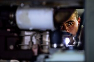 U.S. Air Force Staff Sgt. Jeremy West, 1st Maintenance Squadron aerospace ground equipment craftsman, conducts preventative maintenance and preparation work on a B809D Generator at Langley Air Force Base, Va., Sept. 9, 2015.  The AGE technicians are responsible for maintaining equipment that supplies electricity and hydraulic and air pressure to aircraft. (U.S. Air Force photo by Senior Airman Kayla Newman/Released)