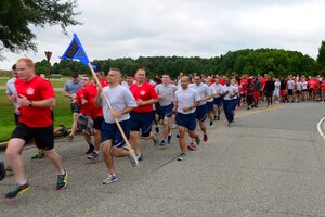 Runners participate in the 9/11 Never Forget Memorial 5K at Langley Air Force Base, Va., Sept. 11, 2015. U.S. Air Force Airmen assigned to the Distributed Ground Station-1 hosted the event, giving members of Joint Base Langley-Eustis the opportunity to honor the historic day’s events. (U.S. Air Force photo by Airmen 1st Class Derek Seifert/ Released)