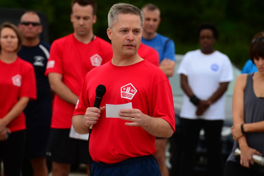 U.S. Air Force Col. Timothy Haugh, 480th Intelligence Surveillance and Reconnaissance wing commander, gives the opening remarks during the 9/11 Never Forget Memorial 5K at Langley Air Force Base, Va., Sept. 11, 2015. During his speech, Haugh recounted the events and praised the first responders who assisted the day of the Sept. 11, 2001 terror attacks. (U.S. Air Force photo by Airmen 1st Class Derek Seifert/ Released)