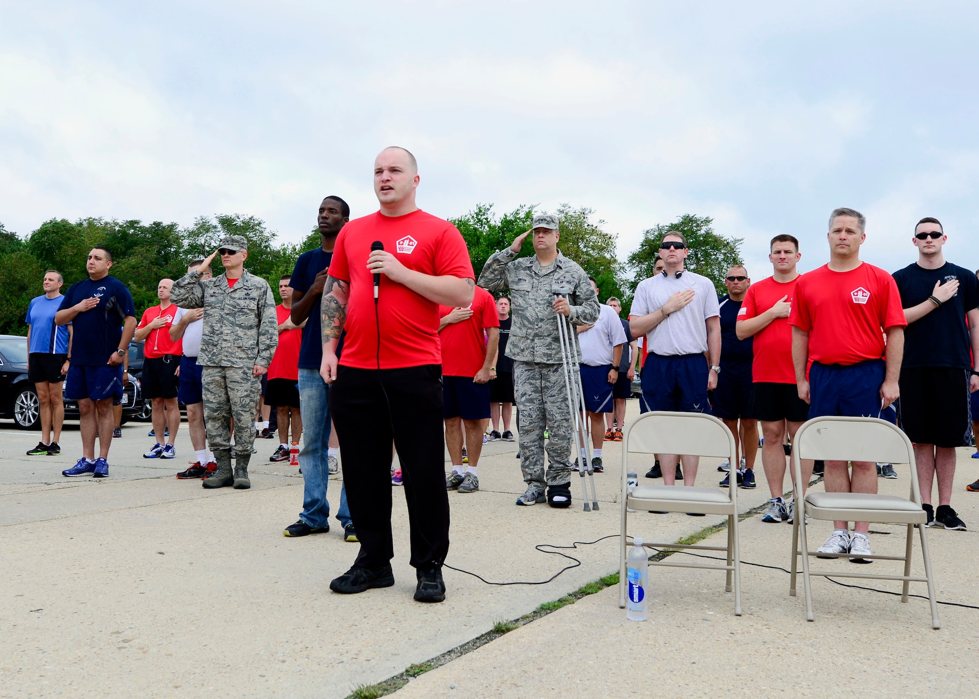 A U.S. Air Force Airman sings the national anthem before the 9/11 Never Forget Memorial 5K at Langley Air Force Base, Va., Sept. 11, 2015. The event was held to show respect to those affected by the terrorist attacks on Sept. 11, 2001. (U.S. Air Force photo by Airmen 1st Class Derek Seifert/Released)