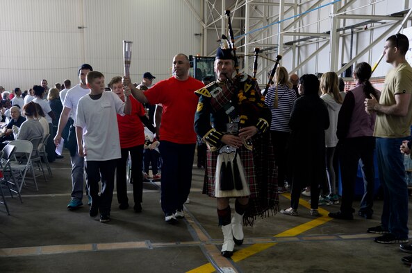 Athletes and volunteers participate in the opening ceremony of Joan Mann Special Sports Day Sept. 12, 2015, on RAF Mildenhall, England. The event was established 34 years ago when Joan Mann, a Ministry of Defence employee on RAF Mildenhall, wanted to find a way to bring local community and military members together to work with special-needs citizens. (U.S. Air Force photo by Senior Airman Victoria H. Taylor/Released)