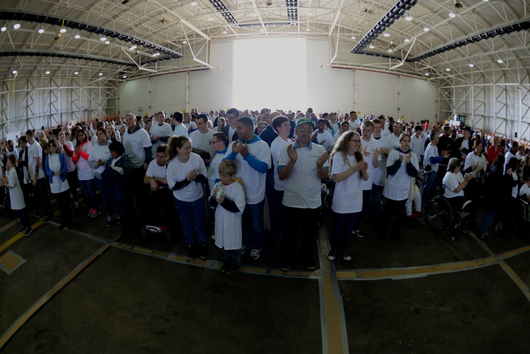 Athletes and volunteers participate in the opening ceremony of Joan Mann Special Sports Day Sept. 12, 2015, on RAF Mildenhall, England. JMSSD is an Olympic-style event featuring a variety of sporting activities for more than 200 special-needs athletes from across England. (U.S. Air Force photo by Senior Airman Victoria H. Taylor/Released)