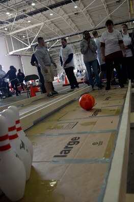 A Joan Mann Special Sports Day athlete attempts to knock down pins during a bowling game at the sporting event Sept. 12, 2015, on RAF Mildenhall, England. Approximately 680 volunteers from RAF Lakenheath and RAF Mildenhall participated in the event supporting more than 200 athletes. (U.S. Air Force photo by Senior Airman Victoria H. Taylor/Released)