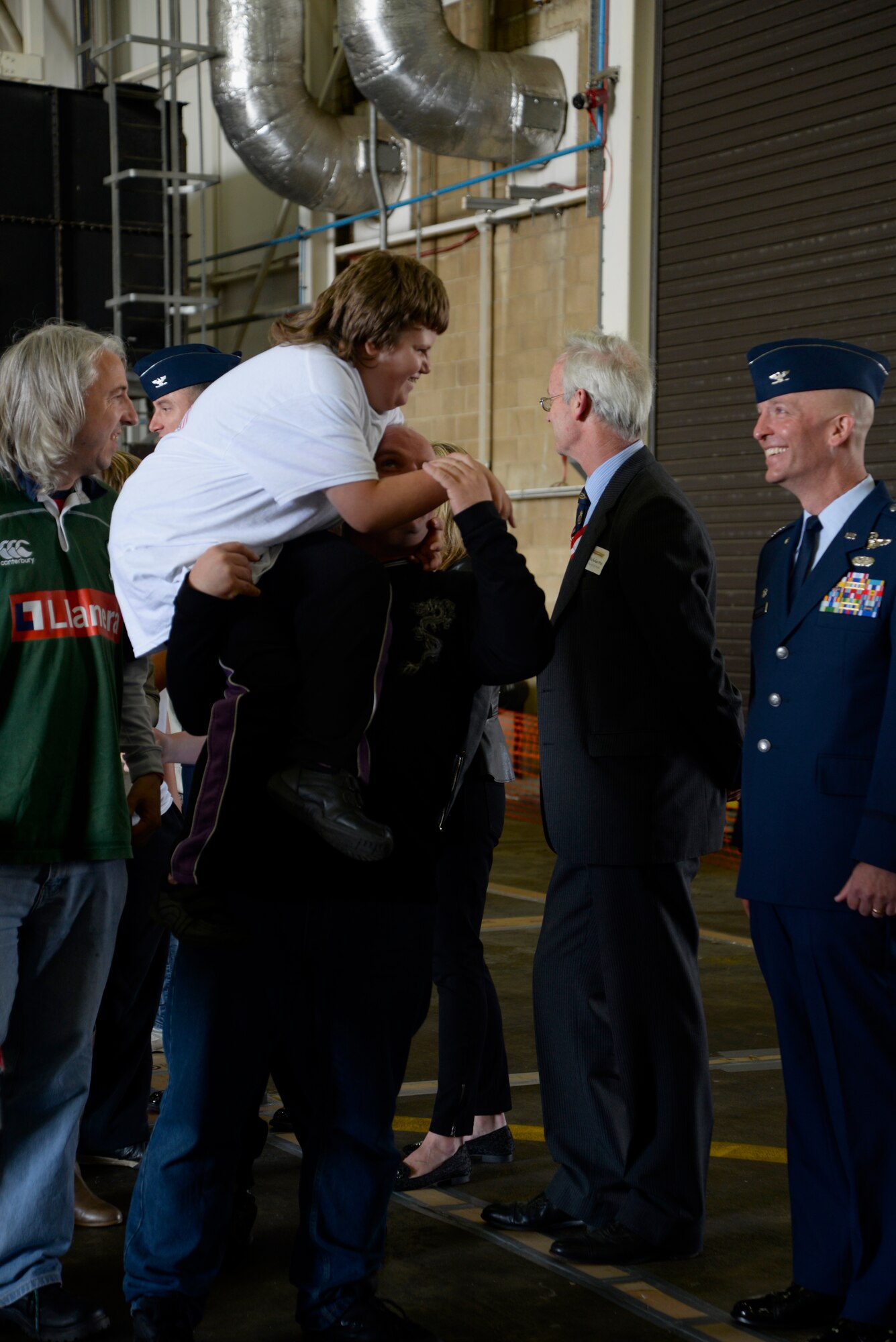 Athletes participating in Joan Mann Special Sports Day greet leadership and honorary commanders during the opening ceremony of JMSSD Sept. 12, 2015, on RAF Mildenhall, England. The occasion is an Olympic-style event featuring a variety of sporting activities for more than 200 special-needs athletes from across England. (U.S. Air Force photo by Senior Airman Victoria H. Taylor/Released)