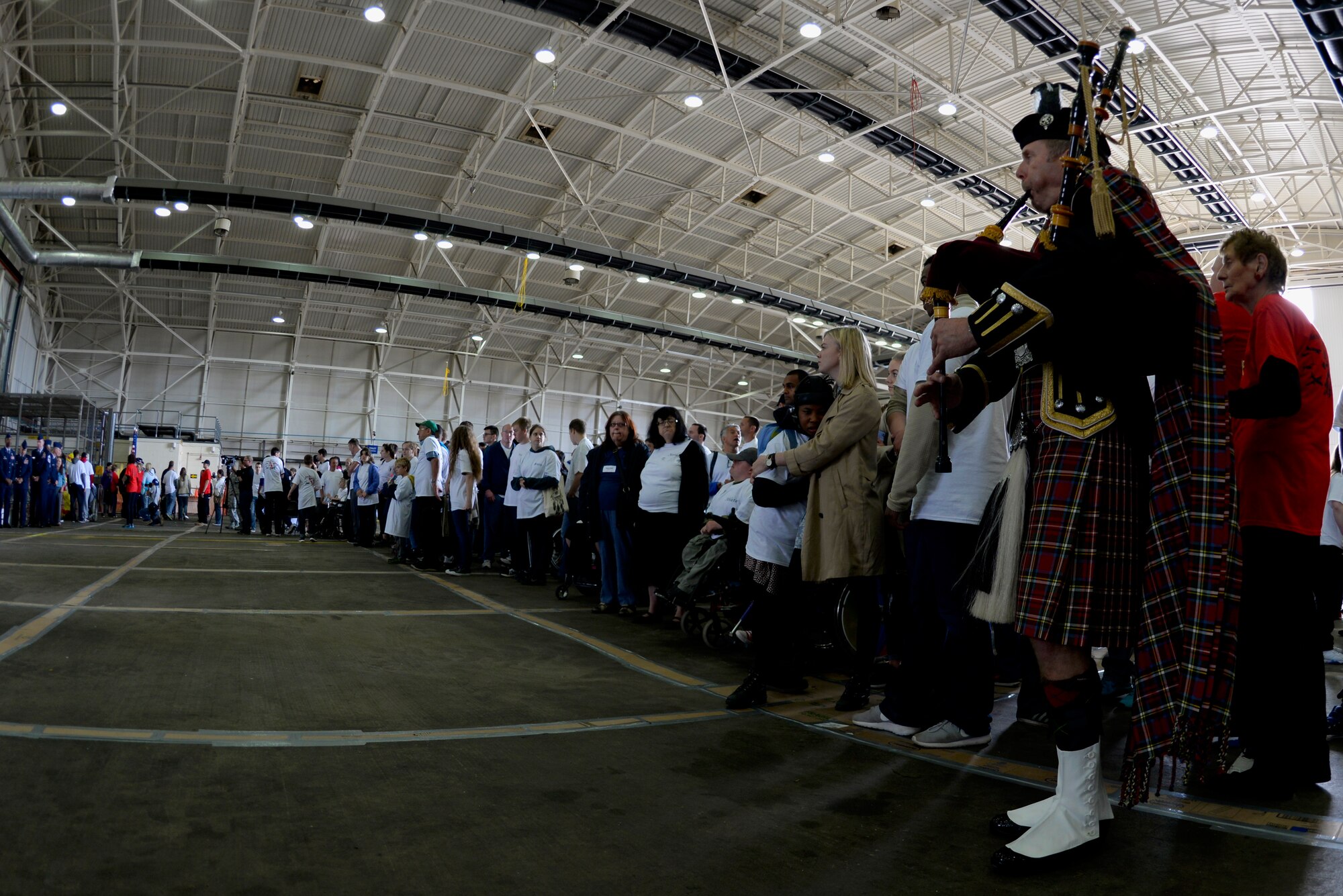 Athletes and volunteers participate in the opening ceremony of Joan Mann Special Sports Day Sept. 12, 2015, on RAF Mildenhall, England. The event was established 34 years ago when Joan Mann, a Ministry of Defence employee on RAF Mildenhall, wanted to find a way to bring local community and military members together to work with special-needs citizens. (U.S. Air Force photo by Senior Airman Victoria H. Taylor/Released)