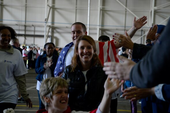 Athletes participating in Joan Mann Special Sports Day greet leadership with high-fives during the opening ceremony Sept. 12, 2015, on RAF Mildenhall, England. The occasion is an Olympic-style event featuring a variety of sporting activities for more than 200 special-needs athletes from across England. (U.S. Air Force photo by Senior Airman Victoria H. Taylor/Released)