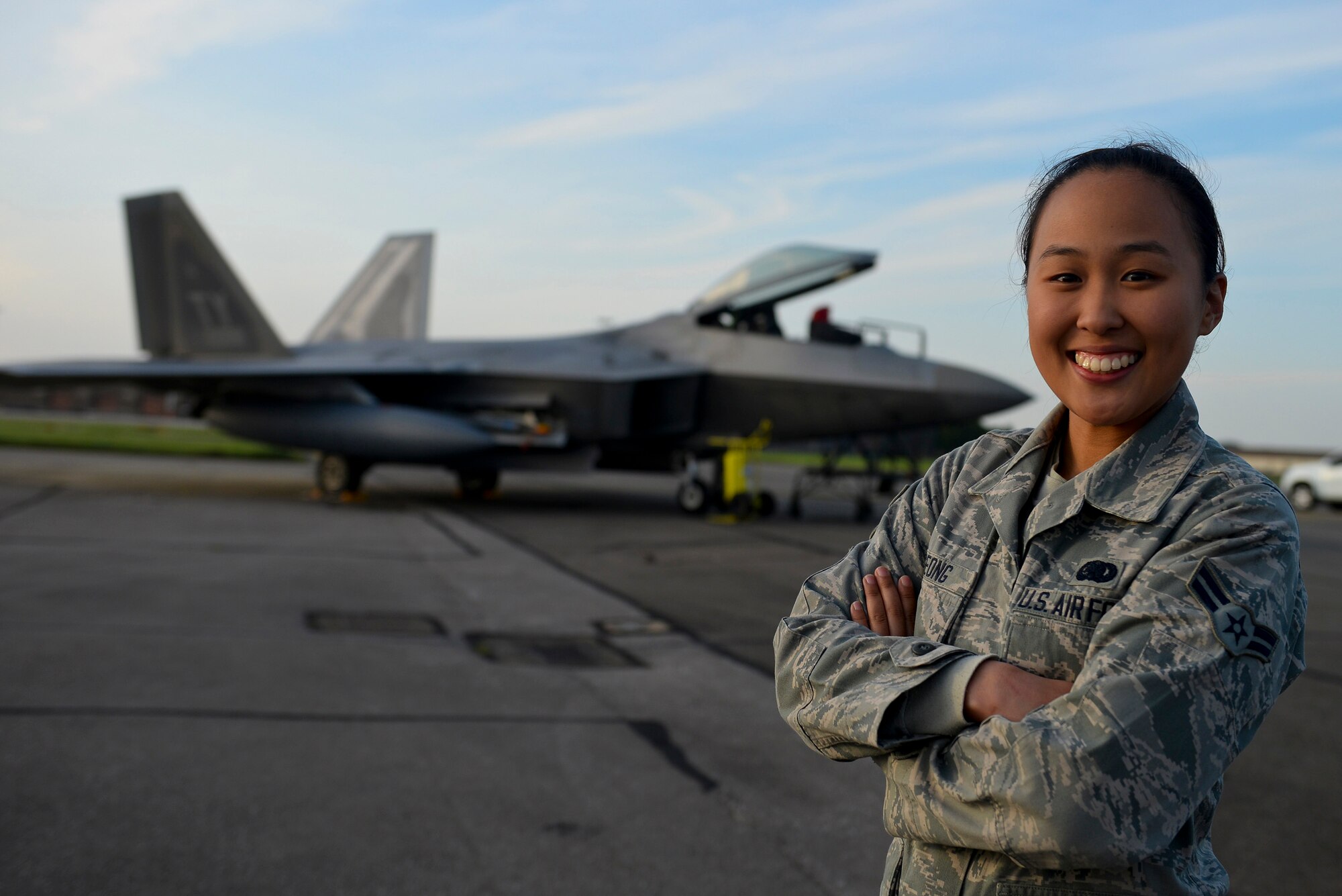 U.S. Air Force Airman 1st Class Ruth Seong, 100th Logistics Readiness Squadron fuels distribution driver, poses for a photo in front of an F-22 Raptor from the 95th Fighter Squadron based at Tyndall Air Force Base, Fla., Sept. 11, 2015, on the flight line at RAF Mildenhall, England. Seong, along with three other Airmen, refueled the transient aircraft shortly after they landed so they would be ready at a moment’ notice. (U.S. Air Force photo by Staff Sgt. Micaiah Anthony/Released)