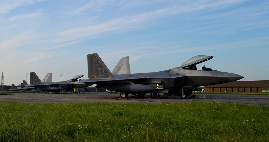 F-22 Raptors from the 95th Fighter Squadron based at Tyndall Air Force Base, Fla., sit on the flightline Sept. 11, 2015, on RAF Mildenhall, England. The aircraft deployed to the European theater to conduct training with other European-based aircraft. (U.S. Air Force photo by Staff Sgt. Micaiah Anthony/Released)