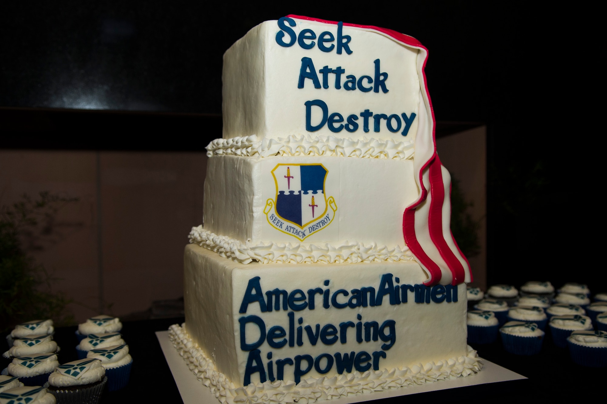 A cake displaying the theme “American Airmen Delivering Airpower” rests atop a table during the Spangdahlem Air Force Ball at Club Eifel on Spangdahlem Air Base, Germany, Sept. 12, 2015. The Club Eifel staff prepared dinner and dessert for more than 250 people at the event.  (U.S. Air Force photo by Airman 1st Class Luke Kitterman/Released)  