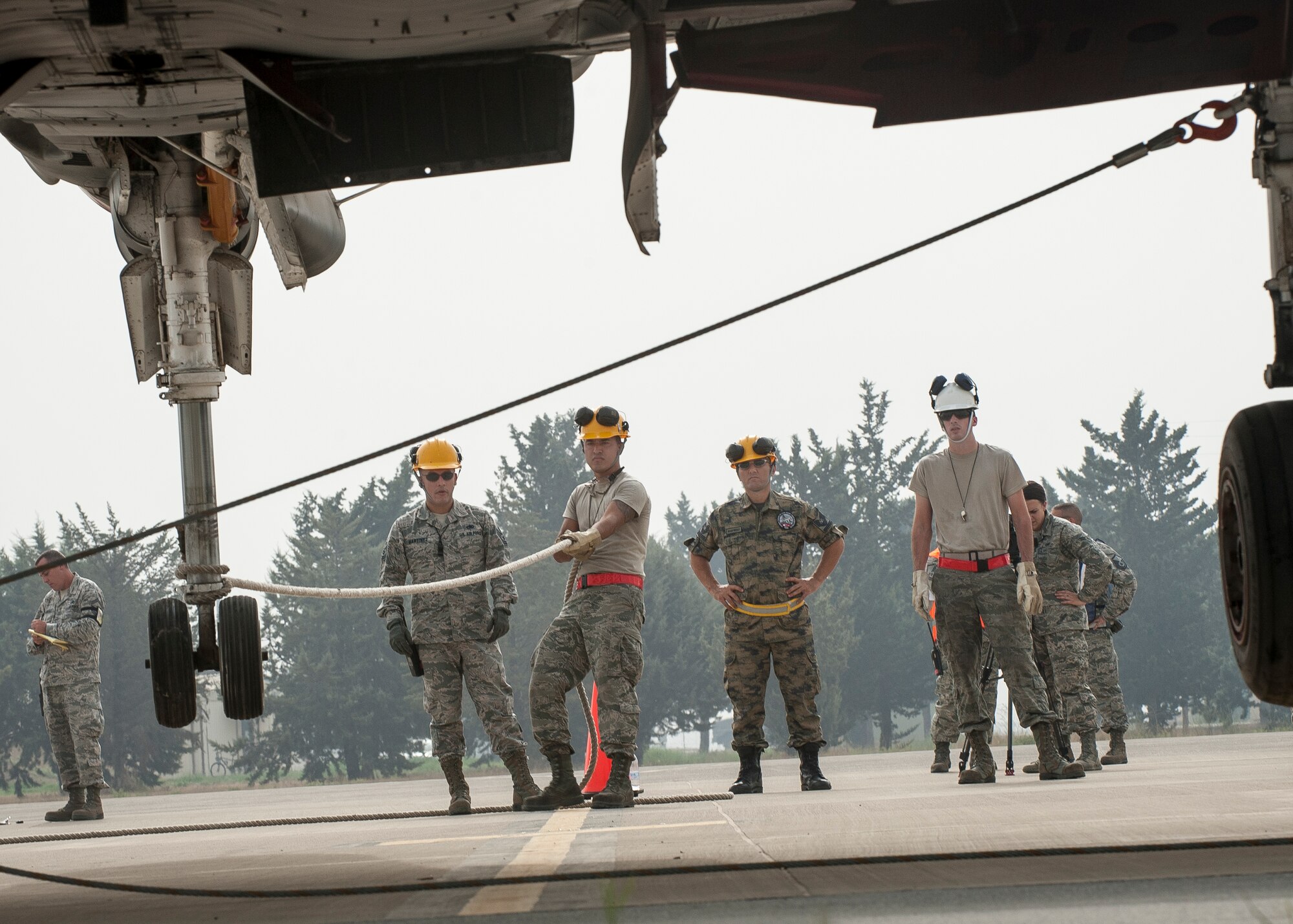 Airmen from the 39th Maintenance Squadron’s Crash, Damaged, Disabled Aircraft Recovery team and 10th Tanker Base Command position the nose gear of a Turkish F-4 aircraft during a joint exercise Sept. 10, 2015, at Incirlik Air Base, Turkey. The Airmen took part in the exercise to improve their skills for emergency situations, as well as an avenue to find ways to improve response procedures. (U.S. Air Force photo by Airman 1st Class Cory W. Bush/Released)