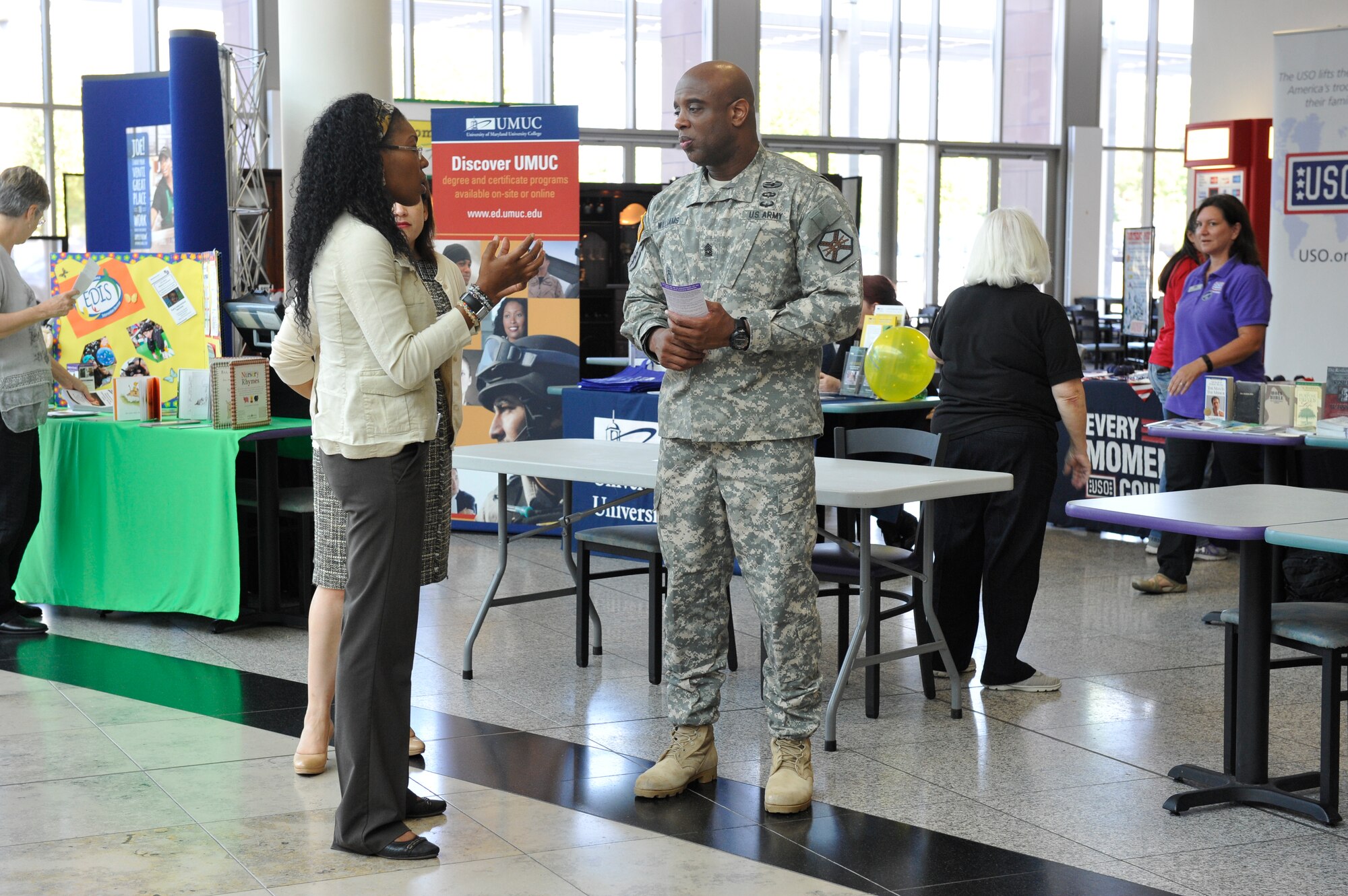 U.S. Army Sgt. Maj. Edward J. Williams III, U.S. Army Garrison Rheinland-Pfalz garrison command sergeant major, speaks to an attendee at the Ready and Resilient information fair at the Kaiserslautern Military Community Center Sept. 11, 2015, at Ramstein Air Base, Germany. Williams opened the information fair by speaking to all the vendors and encouraging them to help as many individuals as they could by providing useful information on all their programs. (U.S. Air Force photo/Staff Sgt. Leslie Keopka)  