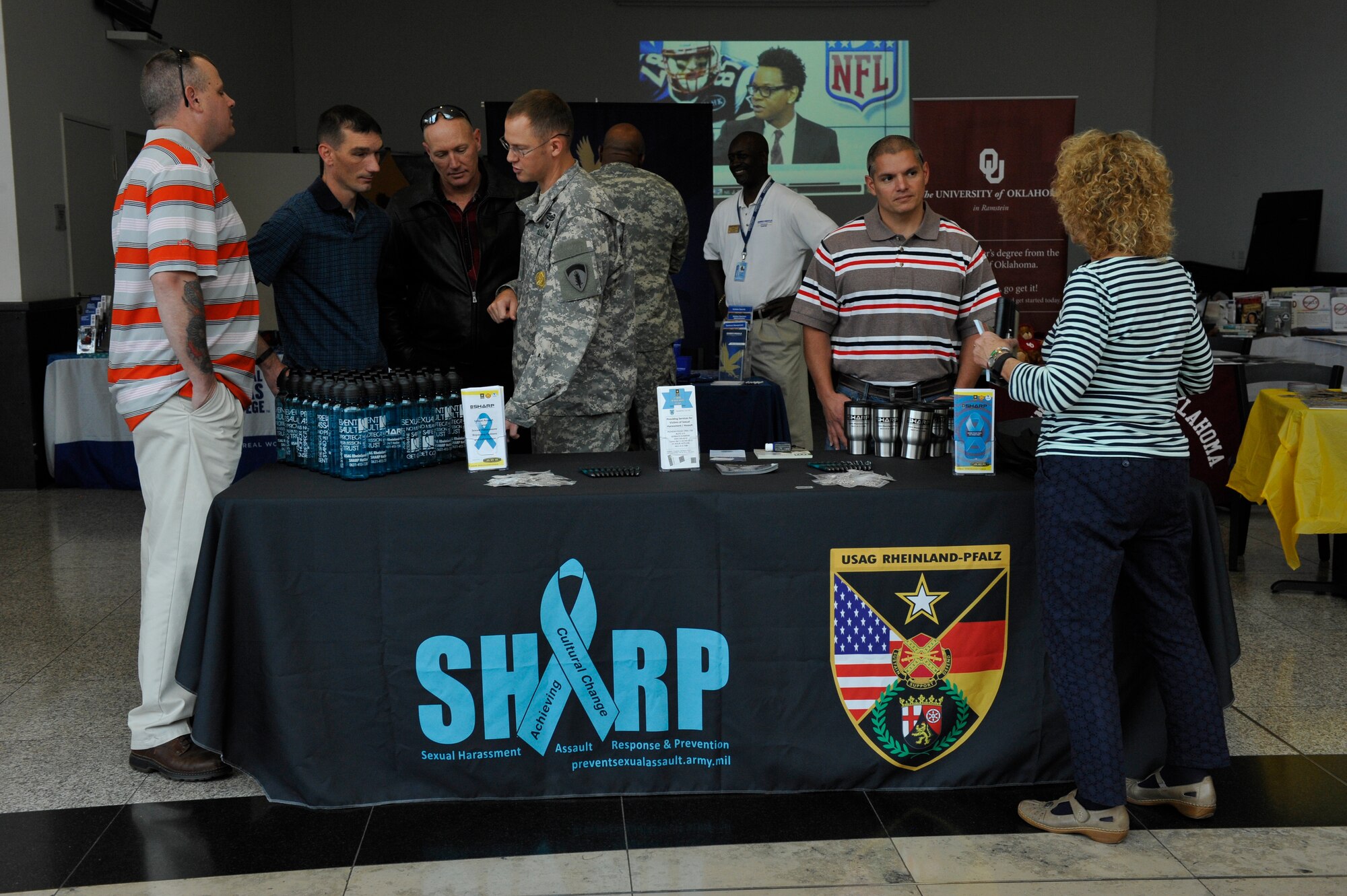 U.S. Army Sgt. 1st Class Lance Clark, 19th Battlefield Coordination Detachment plans NCO in charge and victim advocate, speaks to individuals during the Ready and Resilient information fair at the Kaiserslautern Military Community Center Sept. 11, 2015, at Ramstein Air Base, Germany. Clark was providing attendees information on the Sexual Harassment/Assault Response and Prevention program. (U.S. Air Force photo/Staff Sgt. Leslie Keopka) 