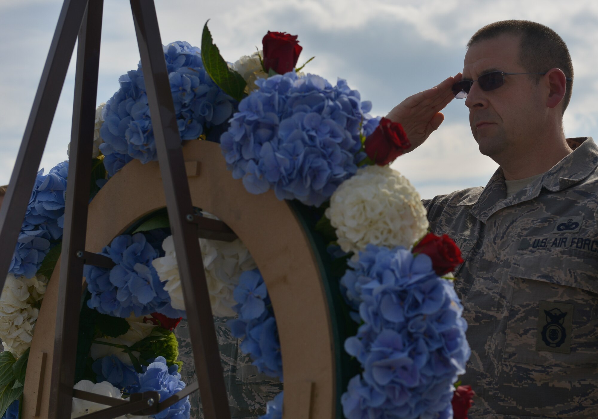 Chief Master Sgt. Edward Keenan, 569th U.S. Forces Police Squadron security forces manager, salutes a wreath on  display during a 9/11 retreat ceremony Sept. 11, 2015, at Ramstein Air Base, Germany. The wreath served as a tribute to the nearly 3,000 lives lost 14 years ago when terrorists hijacked four airplanes resulting in one of the largest domestic terrorist attacks in U.S. history. The ceremony paid tribute to those lost, including the first responders that made the ultimate sacrifice helping people escape the collapsing World Trade Center towers. (U.S. Air Force photo/Airman 1st Class Lane T. Plummer)