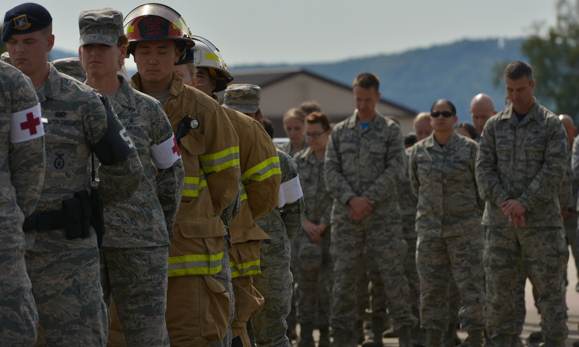 Airmen take a moment of silence during a 9/11 retreat ceremony Sept. 11, 2015, at Ramstein Air Base, Germany. The ceremony paid tribute to the nearly 3,000 lives lost 14 years ago, including the first responders that made the ultimate sacrifice helping those escape the collapsing World Trade Center towers. (U.S. Air Force photo/Airman 1st Class Lane T. Plummer)