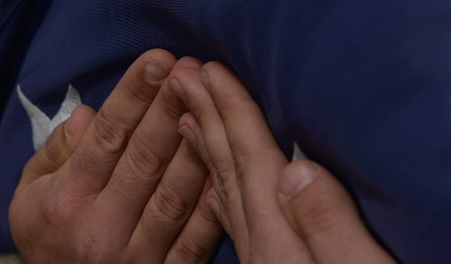 The U.S. flag is held by a Ramstein honor guardsman during the 9/11 retreat ceremony Sept. 11, 2015, at Ramstein Air Base, Germany. The ceremony paid respects to the nearly 3,000 lives lost 14 years ago, including the first responders that helped people escape the collapsing World Trade Center towers. The ceremony, as well as many like it held around the world, echoes George W. Bush’s sentiments after the attacks, “None of us will ever forget this day, yet we go forward to defend freedom and all that is good and just in our world.” (U.S. Air Force photo/Airman 1st Class Lane T. Plummer)