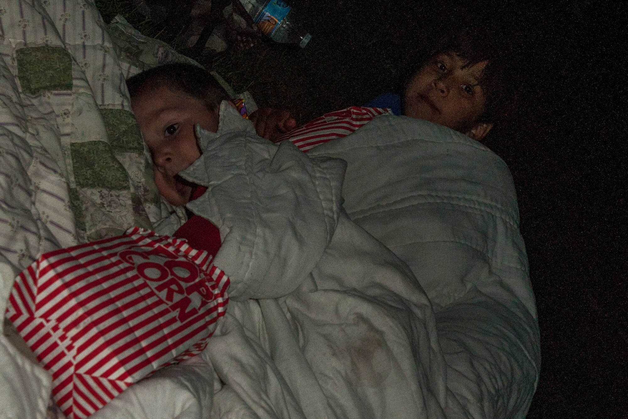 PETERSON AIR FORCE BASE, Colo. – The Horton boys, A.J, 3, and Xavier, 9, get comfortable during the showing of “An American Tail” and the Movie on the Lawn event at Patriot Park Sept. 11, 2015. The Base Chapel put on the event for families to get together before winter prevents outdoor family events. They also provided the snacks for movie-goers. (U.S. Air Force photo by Airman 1st Class Rose Gudex)