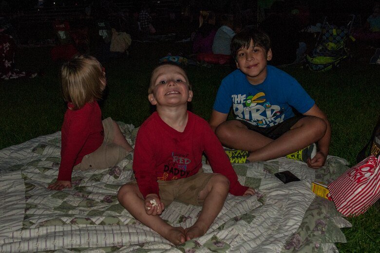 PETERSON AIR FORCE BASE, Colo. –  The Horton boys, A.J, Brandon and Xavier, eat snacks during the showing of “An American Tail” and the Movie on the Lawn event at Patriot Park Sept. 11, 2015. The Base Chapel put on the event for families to get together before winter prevents outdoor family events. They also provided the snacks for movie-goers. (U.S. Air Force photo by Airman 1st Class Rose Gudex)