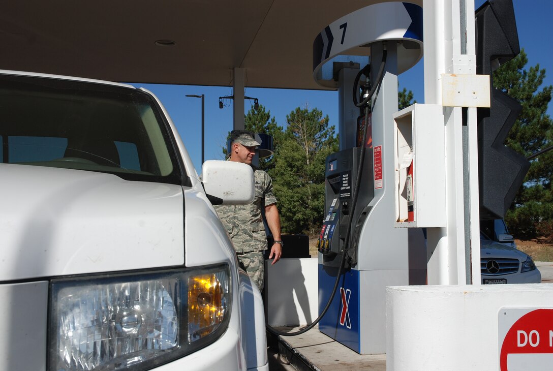 Lt. Col. Mark Corrao, AFSPC, waits patiently as his truck is gassed up at the Peterson shopette. In an effort to keep pricing competitive fuel prices on base are determined by surveying area stations and setting it equal to the lowest of them. (U.S. Air Force Photo, Dave Smith)