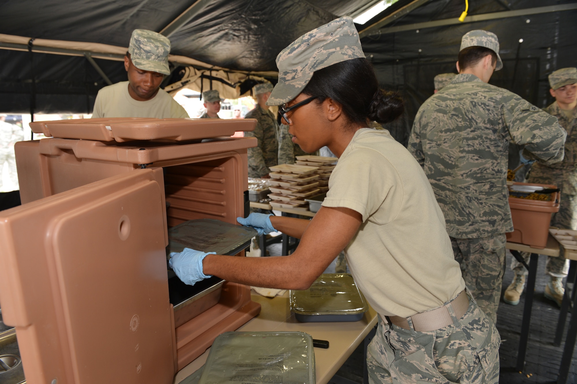 Airman First Class Rebecca Hammock, Senior Airman Taiheem Pleasant and Airman Ethan Haberman, members of the 155th Services Flight, prepare and serve meals to Airmen at the 155th Air Refueling Wing during a Domestic Operations training session, showcasing the Nebraska Air National Guard's capabilities in emergency management to Nebraska Civil leaders, June 5, at the Nebraska National Guard air base, Lincoln, Neb. 