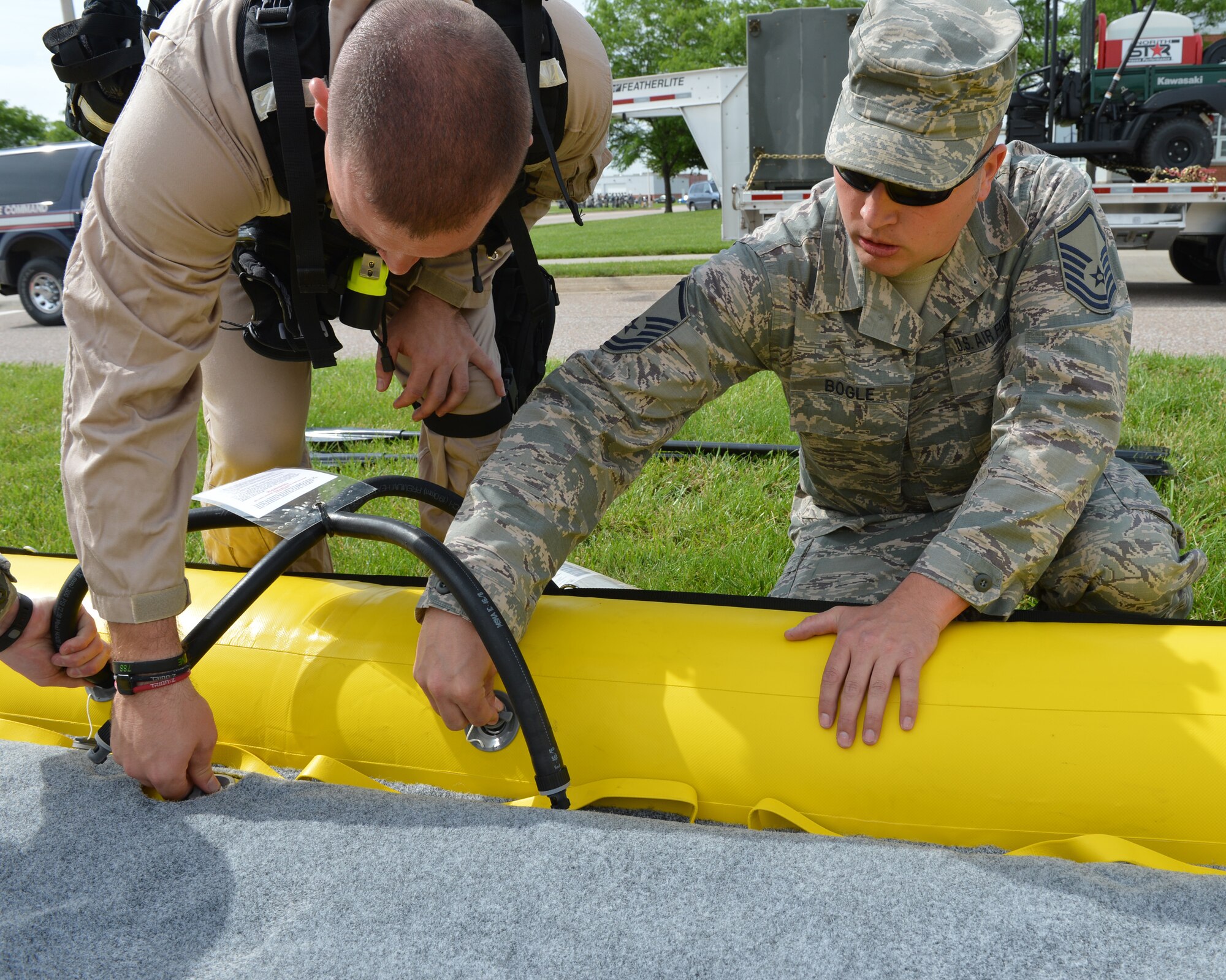 Master Sgt. Robert Bogle, 155th Fire Department, helps inflate a rescue raat the 155th Air Refueling Wing Domestic Operations training session, showcasing the Nebraska Air National Guard's capabilities in emergency management to Nebraska Civil leaders June 5 at the Nebraska National Guard air base, Lincoln, Neb. 