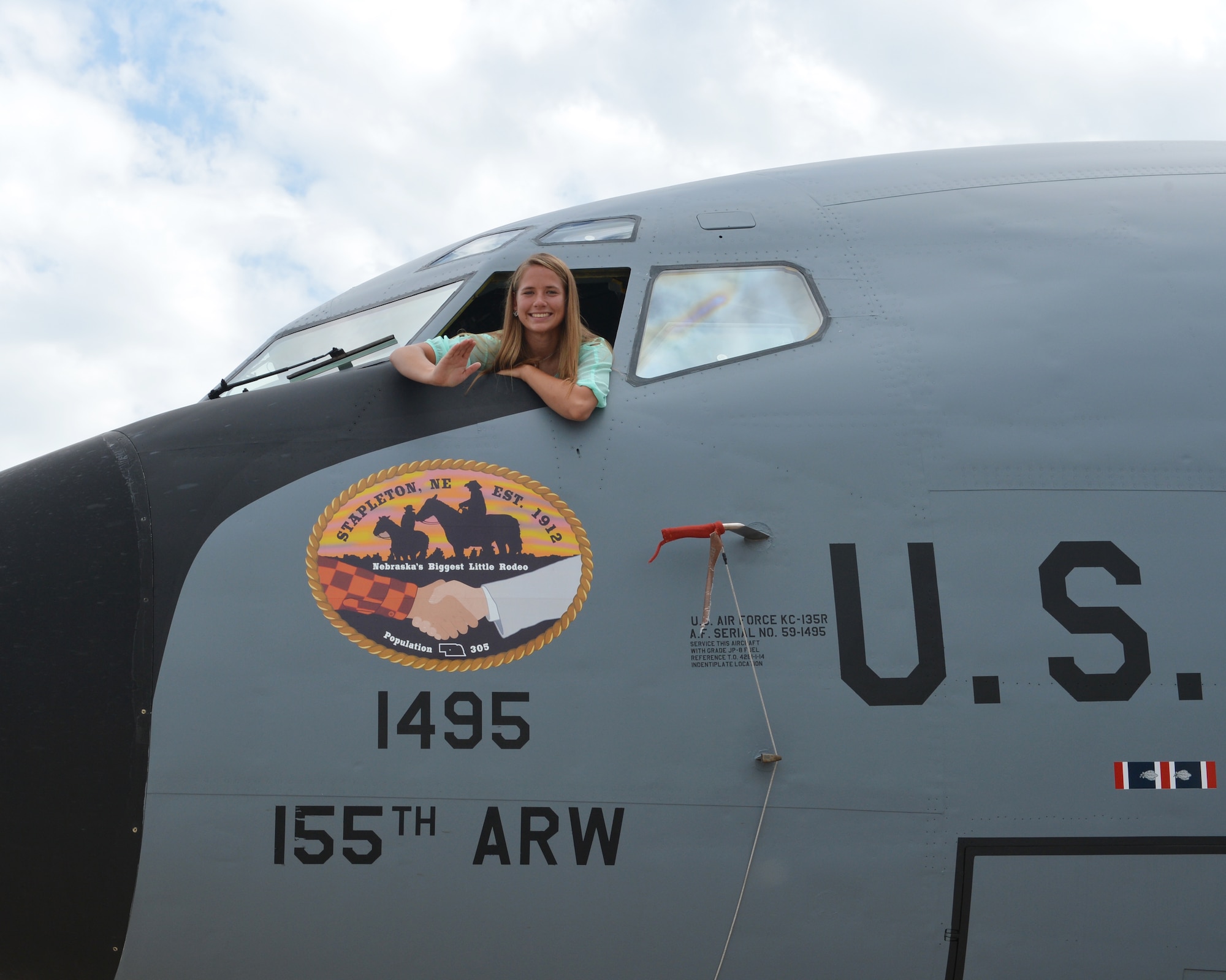 Mariah Harm, a Stapleton, Neb., native and senior at Stapleton High School, unveils her artwork on the nose of a KC-135R Stratotanker at the 155th Air Refueling Wing, Nebraska Air National Guard Base Aug. 8, in Lincoln, Neb.