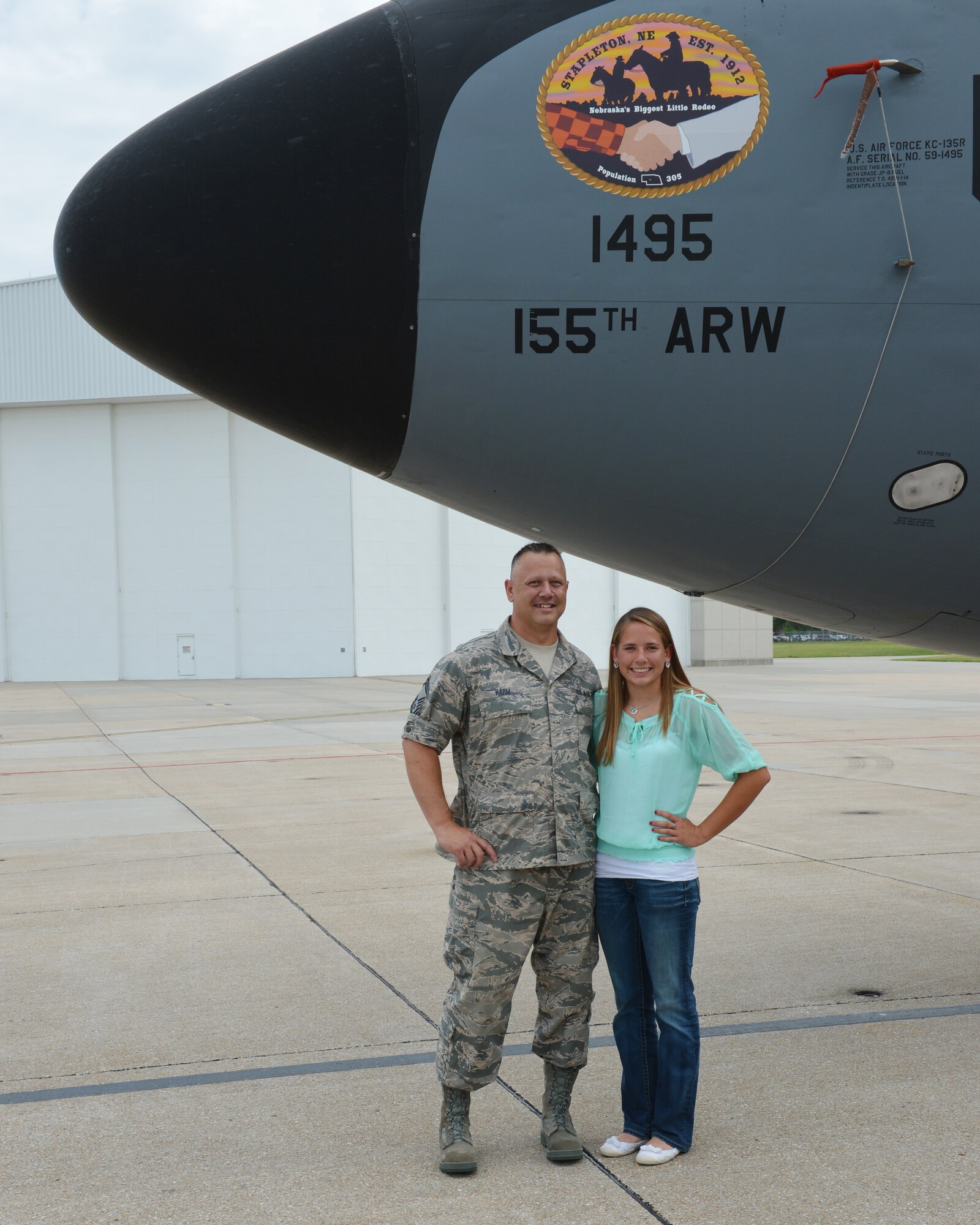 Mariah Harm, a Stapleton, Neb., native and senior at Stapleton High School, stands with her father, Senior Master Sgt. Toby Harm, after unveiling her artwork on the nose of a KC-135R Stratotanker at the 155th Air Refueling Wing, Nebraska Air National Guard Base Aug. 8, in Lincoln, Neb.