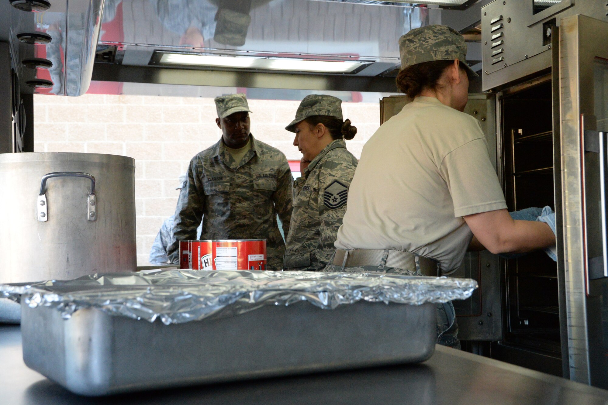 U.S. Air Force Airmen with the 123rd Air Wing, Kentucky Air National Guard, assist and train 181st Intelligence Wing Services Flight Airmen on the use of a Disaster Relief Mobile Kitchen Trailer at Hulman Field, Terre Haute, Ind., Sept. 13, 2015. (U.S. Air National Guard photo by Airman 1st Class Kevin D. Schulze/Released) 