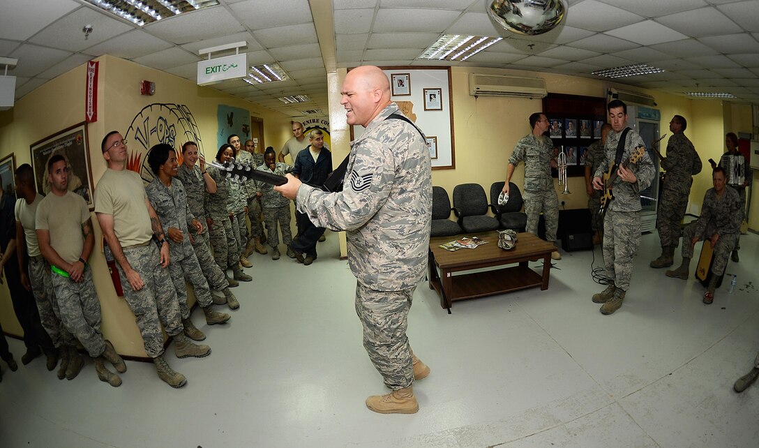 Tech. Sgt. Jason Cale,  Air Forces Central Command band guitarist, performs for 380th Expeditionary
Logistics Readiness Squadron Airmen at an undisclosed location in Southwest Asia, Aug. 26, 2015. The  AFCENT band is charged with keeping spirits high in the Central Command Area of Responsibility. (U.S. 
 Air Force photo by Staff Sgt. Emerson Nuñez/Released)