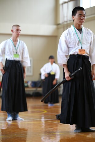 Students from Matthew C. Perry High School aboard Marine Corps Air Station Iwakuni, Japan and Yanai City stand ready to learn a Japanese sword dance during a field trip to the Monk Gessho Exhibition Hall August 22, 2015. The dance was instructed by Mitsuharu Nishihara who volunteered to help on the field trip. Nishihara also serves as Yanai City’s chairman of the Board of Education.