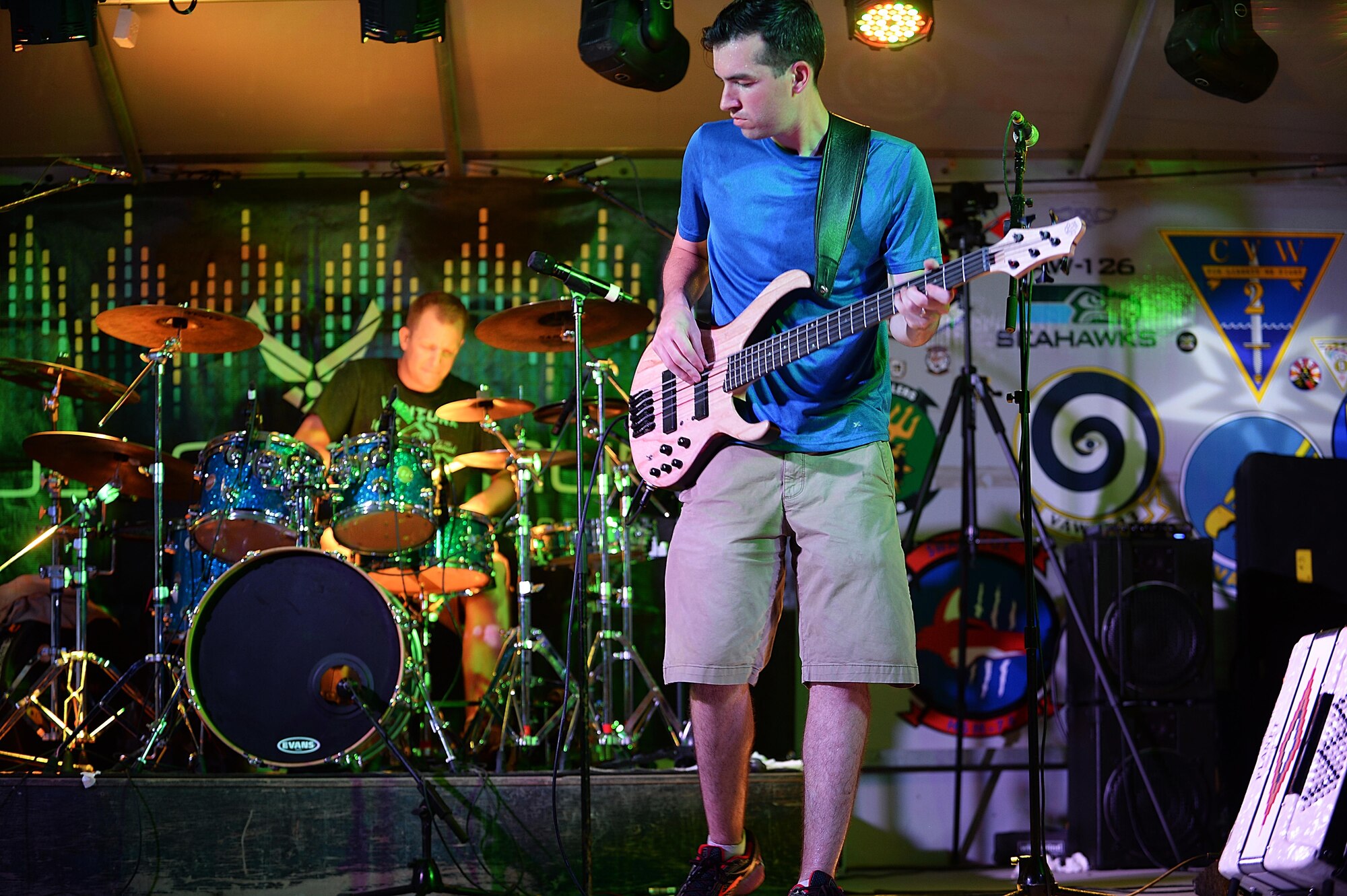 Staff Sgt. Jordan Kimble, Air Forces Central Command bass player, performs at a concert for service
members at an undisclosed location in Southwest Asia, Aug. 27, 2015. The AFCENT band is composed of 
musicians who perform and tour throughout the Central Command Area of Responsibility to encourage 
troop morale, diplomacy and outreach to host nation communities. (U.S. Air Force photo by Staff Sgt. 
Emerson Nuñez/Released)