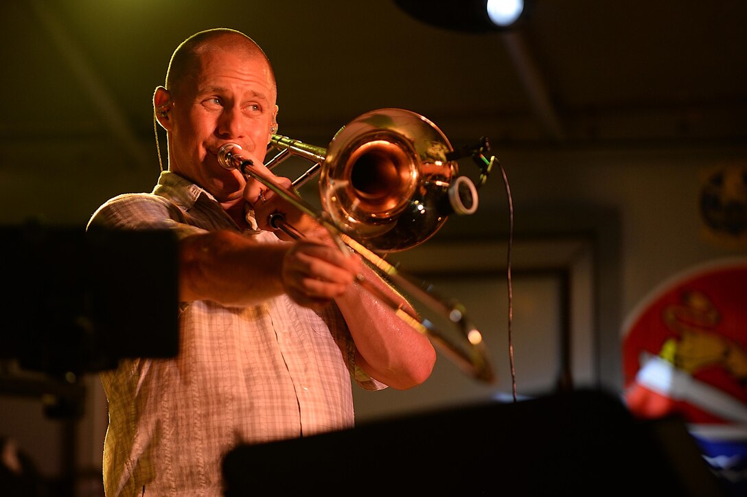 Staff Sgt. Trent Lockhart, Air Forces Central Command trombone player, performs for service members 
during a concert at an undisclosed location in Southwest Asia, Aug. 27, 2015. The AFCENT band is 
deployed to Al Udeid Air base, Qatar and conducts tours around the Central Command Area of 
Responsibility as frequently as possible. (U.S. Air Force photo by Staff Sgt. Emerson Nuñez/Released)