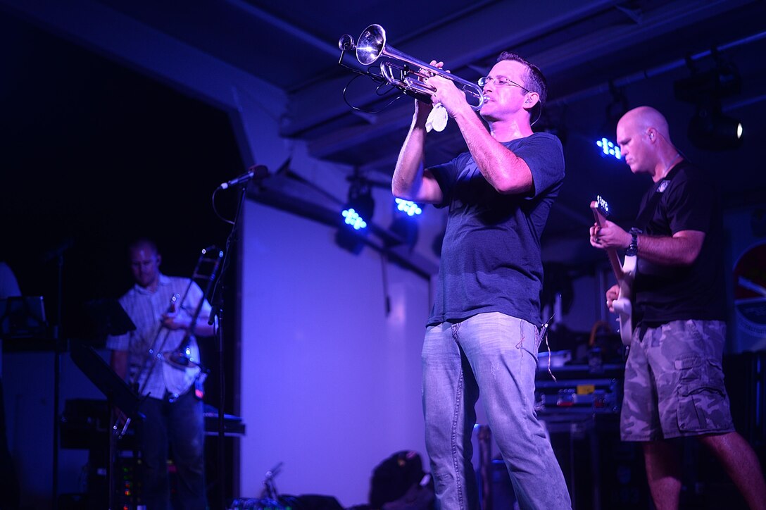 Senior Airman Mark Oates, Air Forces Central Command Band trumpet player, performs for service
members during a concert at an undisclosed location in Southwest Asia, Aug. 27, 2015. The AFCENT 
band is comprised of musicians who perform and tour throughout the area of responsibility to 
encourage troop morale, diplomacy and outreach to host nation communities. (U.S. Air Force photo by 
Staff Sgt. Emerson Nuñez/Released)