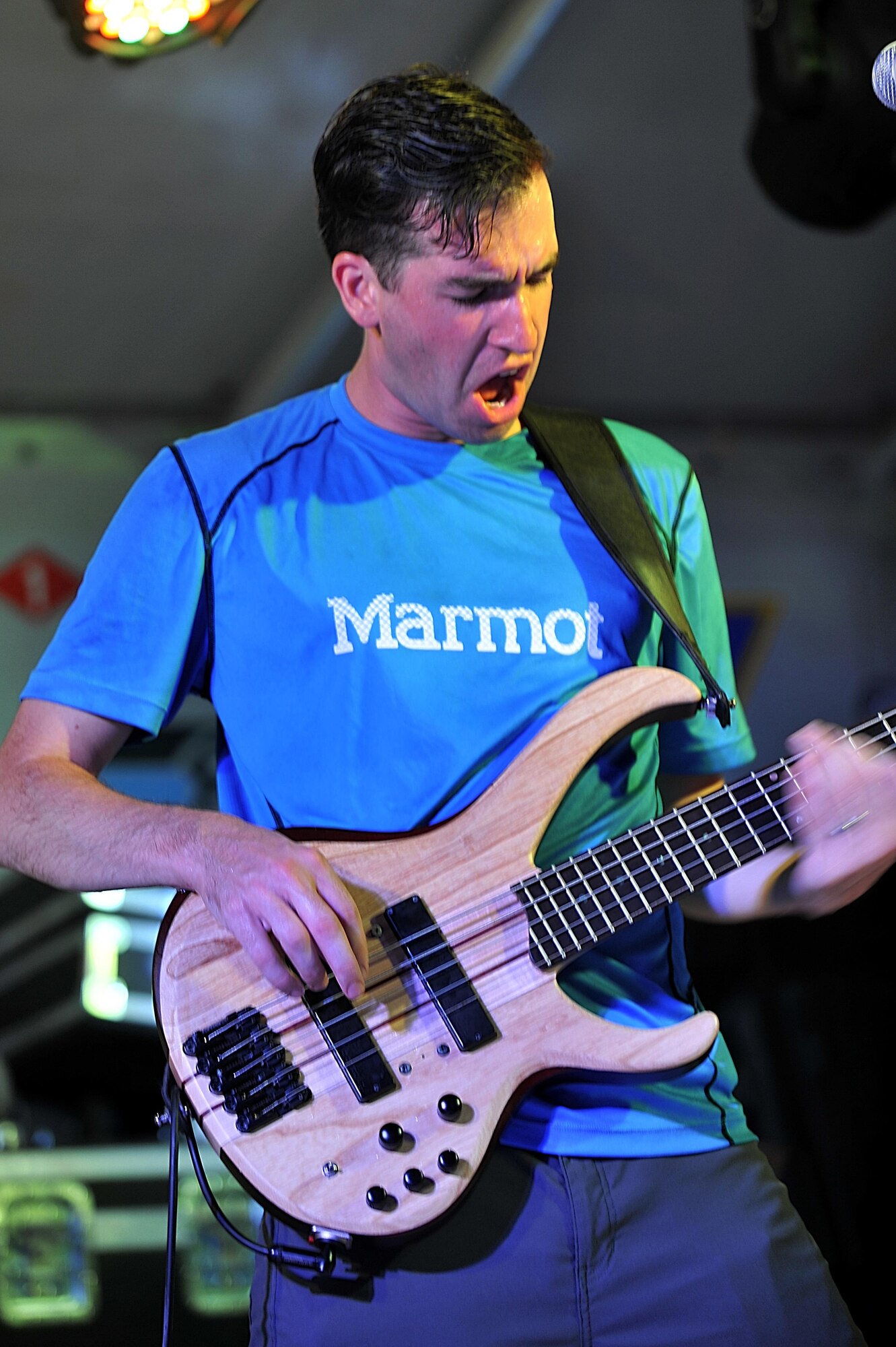 Staff Sgt. Jordan Kimble, Air Forces Central Command bass
player, performs for service members during a concert at an 
undisclosed location in Southwest Asia, Aug. 27, 2015. The 
AFCENT band is charged with keeping spirits high throughout 
the Central Command Area of Responsibility. (U.S. Air Force 
photo by Staff Sgt. Emerson Nuñez/Released)