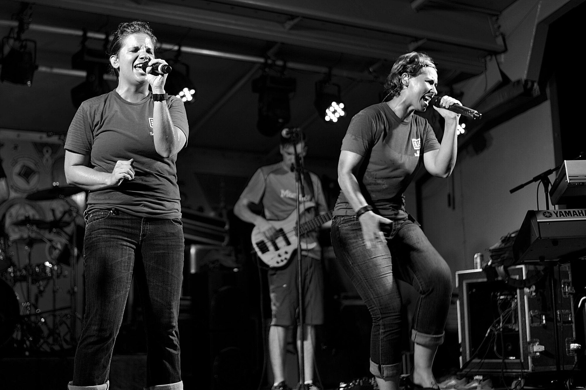 Senior Airman Melissa Lackore, left, and Staff Sgt. Michelle Hooper, Air Forces Central Command band
members sing for service members during a concert at an undisclosed location in Southwest Asia, Aug. 
29, 2015. The band uses music as a tool to boost troop morale. (U.S. Air Force photo by Staff Sgt. 
Emerson Nuñez/Released)