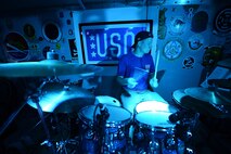 Tech. Sgt. Bennett Weidemann, Air Forces Central Command band drummer, plays the drums during a
concert for military members at an undisclosed location in Southwest Asia, Aug. 29, 2015. The band 
plays a variety of genres of music to appeal to all audiences. (U.S. Air Force photo by Staff Sgt.Emerson 
Nuñez/Released)