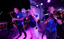 The Air Forces Central Command band horn section, perform for service members during a concert at an 
undisclosed location in Southwest Asia, Aug. 28, 2015. The AFCENT band is composed of musicians who 
perform and tour throughout the Central Command Area of Responsibility to encourage troop morale, 
diplomacy and outreach to host nation communities. (U.S. Air Force photo by Staff Sgt. Emerson 
Nuñez/Released)