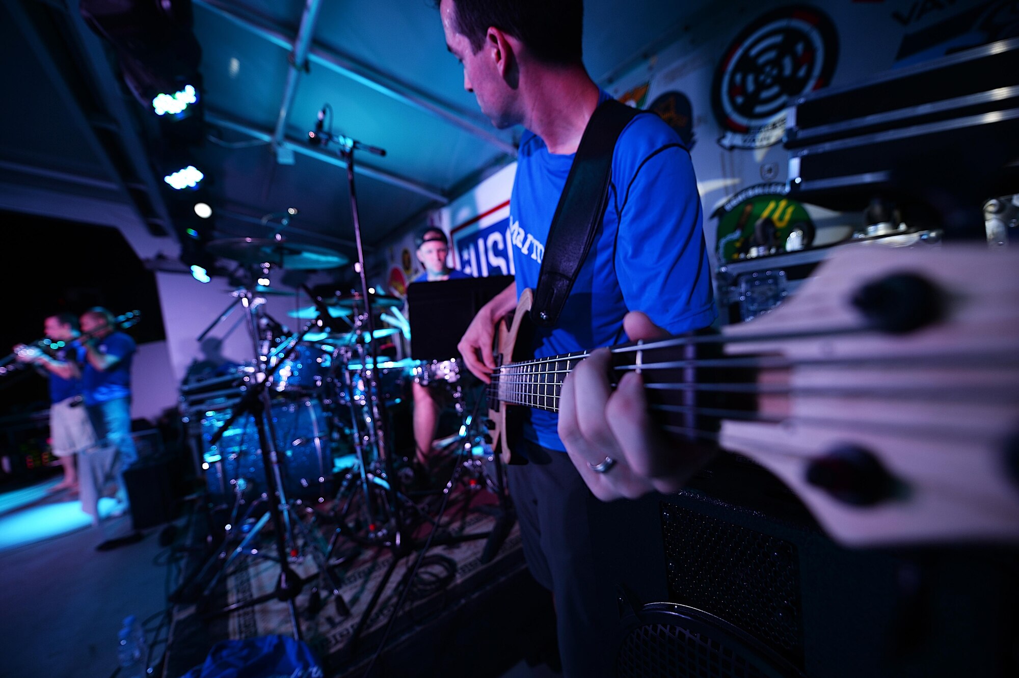 Staff Sgt. Jordan Kimble, Air Forces Central Command bass player, performs for service members during 
a concert at an undisclosed location in Southwest Asia, Aug. 29, 2015. The AFCENT band is chargedwith 
keeping spirits high throughout the Central Command Area of Responsibility. (U.S. Air Force photo by 
Staff Sgt. Emerson Nuñez/Released)