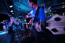 Staff Sgt. Jordan Kimble, Air Forces Central Command bass player, performs for service members during 
a concert at an undisclosed location in Southwest Asia, Aug. 29, 2015. The AFCENT band is chargedwith 
keeping spirits high throughout the Central Command Area of Responsibility. (U.S. Air Force photo by 
Staff Sgt. Emerson Nuñez/Released)
