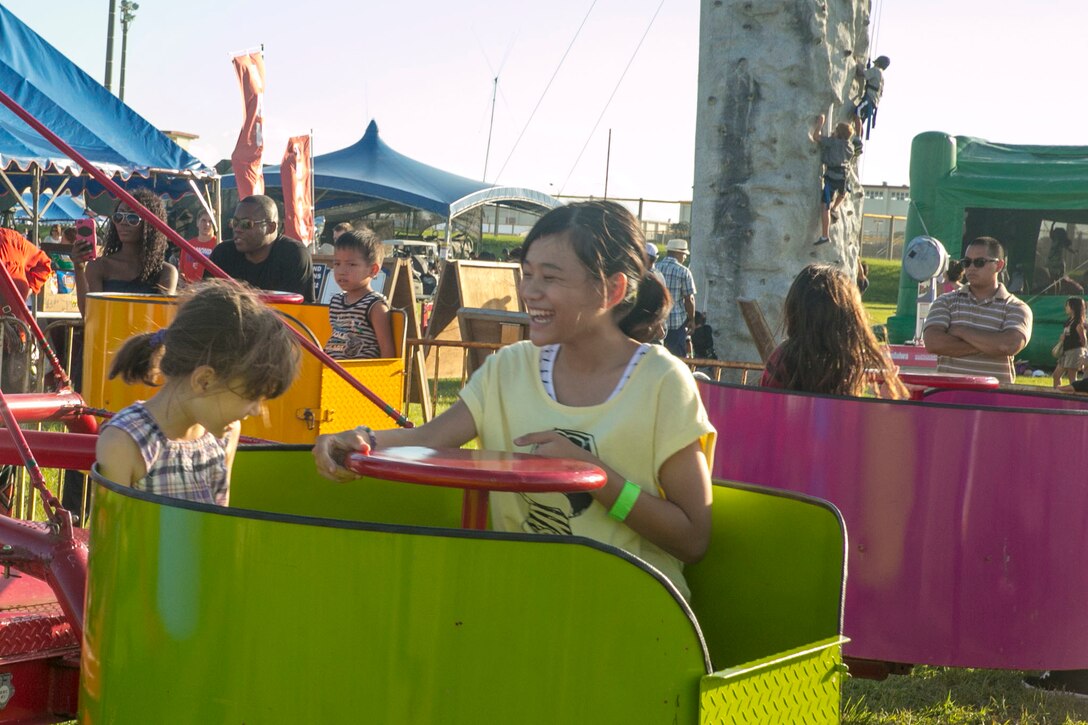 Okinawan citizens enjoy carnival rides during HansenFest, on Camp Hansen, Okinawa, Japan, Sept. 5, 2015.  The Marine Corps Community Services opened Camp Hansen’s gates for Okinawan citizens, military families, and service members to enjoy the carnival rides, festive foods and live music from Madison Rising and Shinedown. The MCCS mission is to take care of Marines and their families by providing quality of life programs, products, and services in support of the Marine Corps objectives. 