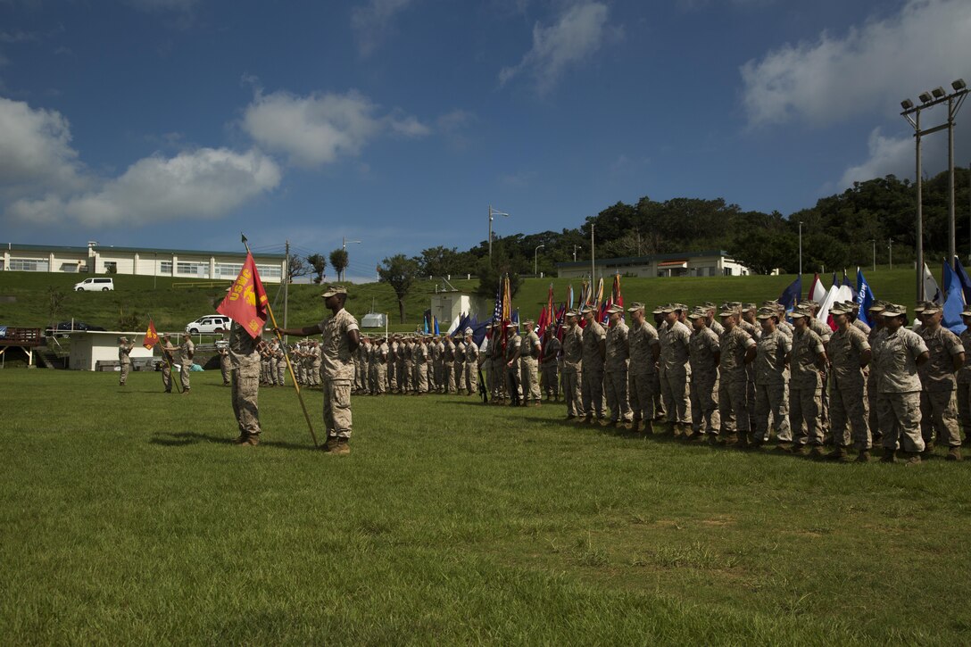 Marines with 3rd Marine Division honor their history as the III Marine Expeditionary Force Band plays the opening song for the division’s 73rd Anniversary, which took place at Camp Courtney, Okinawa, Japan, Sept. 4, 2015. The ceremony honored past and present Marines, and the history behind the “Fighting Third.” The Marines are with various units under 3rd Marine Division, III MEF.