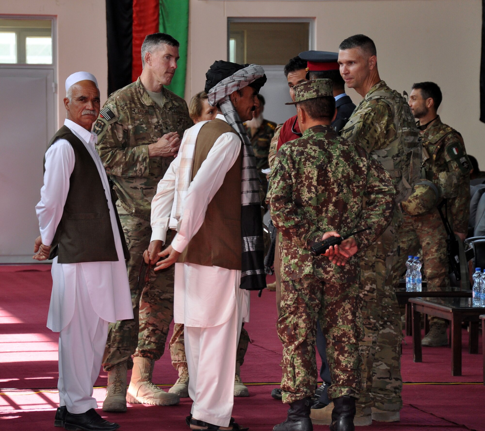 Brig. Gen. Christopher Craige, commanding general of Train, Advise, Assist Command - Air (TAAC-Air) talks to several Afghan guests at an officer candidate school training ceremony at Pohantoon-e-Hawayee (PeH), or Afghan Air Academy, in early September. Approximately 189 Afghan Air Force cadets began their year-long. The Afghan OCS program focuses on English language, leadership and aviation studies. The cadets will fill required slots for the AAF in various air force careers in maintenance, flight engineering and pilots. 
(U.S. Air Force photo by Capt. Eydie Sakura/Released)
